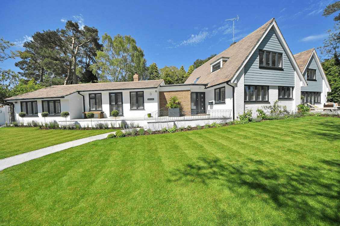 A lush, green residential lawn with precise mowing lines
