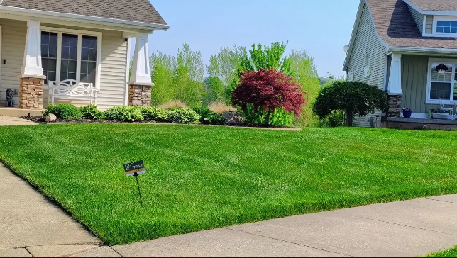 Clean beds and edges from residential lawn mowing services keep front yards looking finished after the growing season.